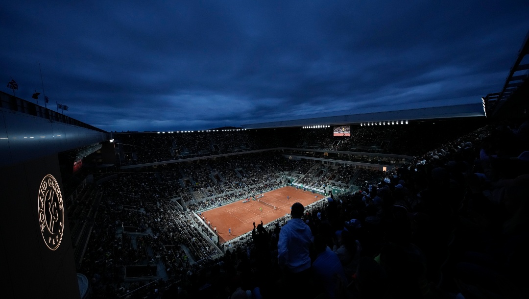FILE - Night sets over center court Philippe Chatrier during the second round match between Spain's Rafael Nadal and France's Corentin Moutet at the French Open tennis tournament in Roland Garros stadium in Paris, France, Wednesday, May 25, 2022. This year's French Open will be the first since 1998 with neither Rafael Nadal nor Roger Federer in the field.(AP Photo/Christophe Ena, File)