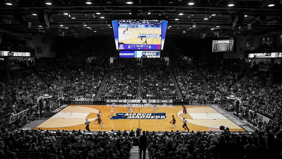 FILE - In this March 19, 2019, file photo, spectators watch from the stands during the first half of a First Four game of the NCAA college basketball tournament between Temple and Belmont, in Dayton, Ohio. NCAA President Mark Emmert says NCAA Division I basketball tournament games will be played without fans in the arenas because of concerns about the spread of coronavirus. (AP Photo/John Minchillo, File)