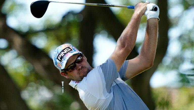 Corey Conners, of Canada, plays his shot from the second tee during the third round of the Sony Open golf tournament.