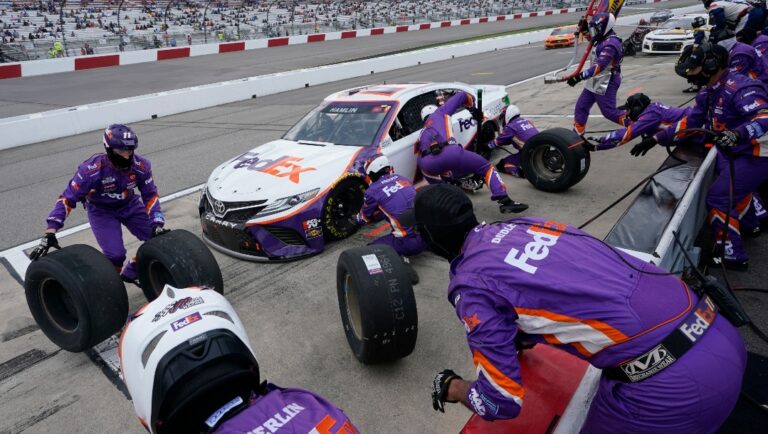 Denny Hamlin (11) gets service in the pits during the NASCAR Cup Series auto race at Richmond International Raceway in Richmond, Va., Sunday, April 18, 2021. (AP Photo/Steve Helber)