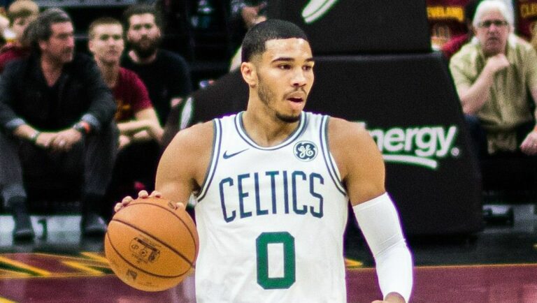 Jayson Tatum of the Boston Celtics dribbles the ball up the court.