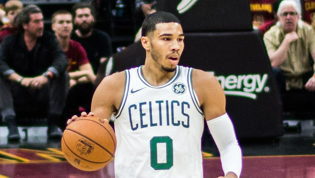 Jayson Tatum of the Boston Celtics dribbles the ball up the court.