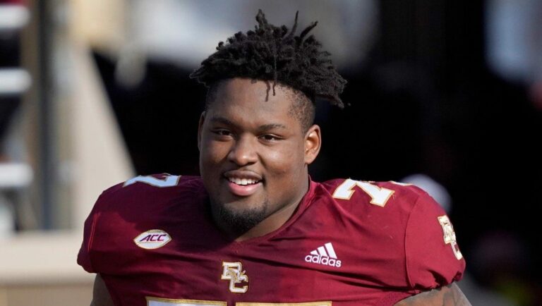 Boston College offensive lineman Zion Johnson (77) smiles as he is introduced during senior day before the start of an NCAA college football game against Wake Forest, Saturday, Nov. 27, 2021, in Boston.