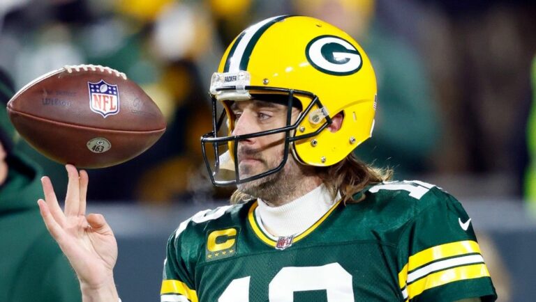 Green Bay Packers quarterback Aaron Rodgers (12) spins a football in his fingers before an NFL divisional playoff football game against the San Francisco 49ers, on Jan 22. 2022, in Green Bay, Wis.