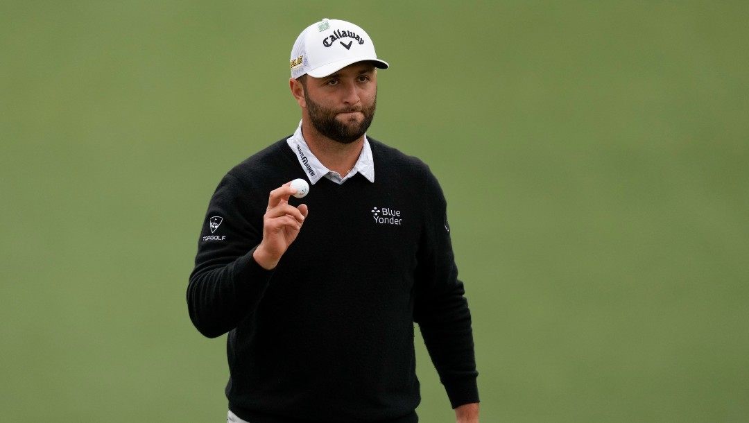 Jon Rahm, of Spain, holds up his ball after a birdie on the second hole during the third round at the Masters golf tournament on Saturday, April 9, 2022, in Augusta, Ga.