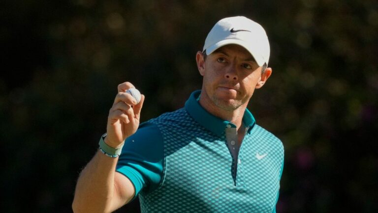 Rory McIlroy, of Northern Ireland, holds up his ball after making an eagle putt on the 13th hole during the final round at the Masters golf tournament on Sunday, April 10, 2022, in Augusta, Ga.