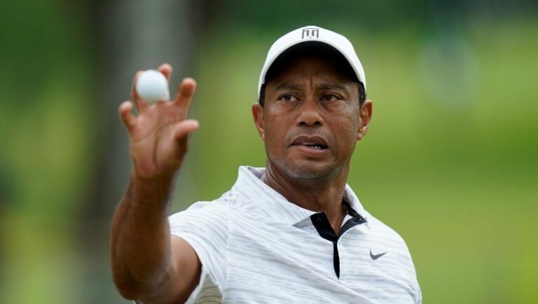 Tiger Woods catches a ball on the driving range before a practice round for the PGA Championship golf tournament, Tuesday, May 17, 2022, in Tulsa, Okla.
