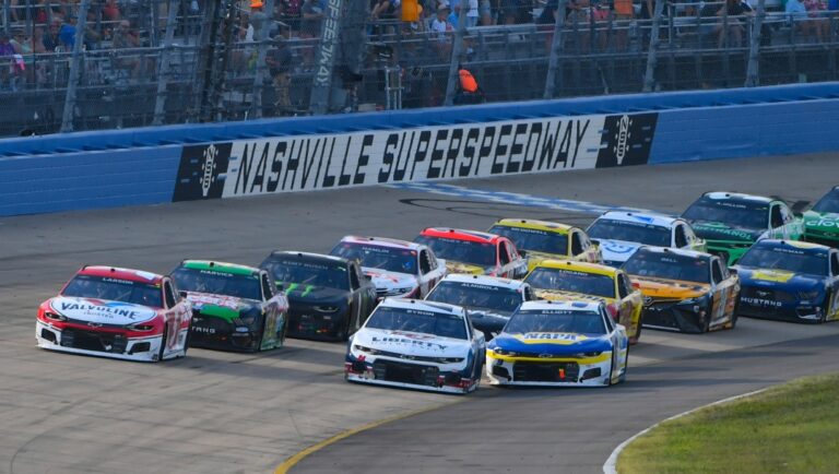 Kyle Larson, far left, and William Byron lead as Chase Elliott, front right, goes low to try to pass during a NASCAR Cup Series auto race Sunday, June 20, 2021, in Lebanon, Tenn. (AP Photo/John Amis)
