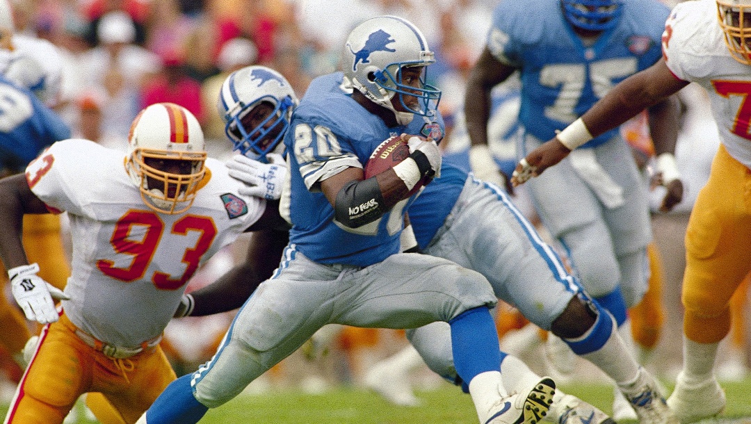 Detroit Lions running back Barry Sanders high steps past Tampa Bay’s Demetrius DuBose (93) during a first half run at Tampa Stadium, Florida on Oct. 2, 1994. Sanders rushes for 166 yards during the Lions 24-14 loss to the Bucs.