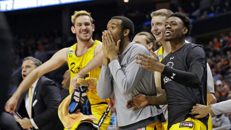 FILE - In this March 16, 2018, file photo, UMBC players celebrate a teammate's basket during the second half against Virginia at the NCAA men's college basketball tournament in Charlotte, N.C. UMBC defeated Virginia 74-54.