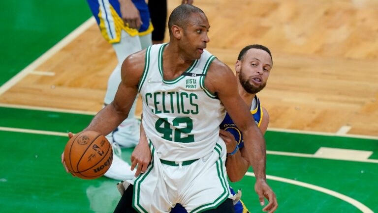 Boston Celtics center Al Horford (42) looks to drive against Golden State Warriors guard Stephen Curry (30) during the third quarter of Game 6 of basketball's NBA Finals, Thursday, June 16, 2022, in Boston. (AP Photo/Steven Senne)