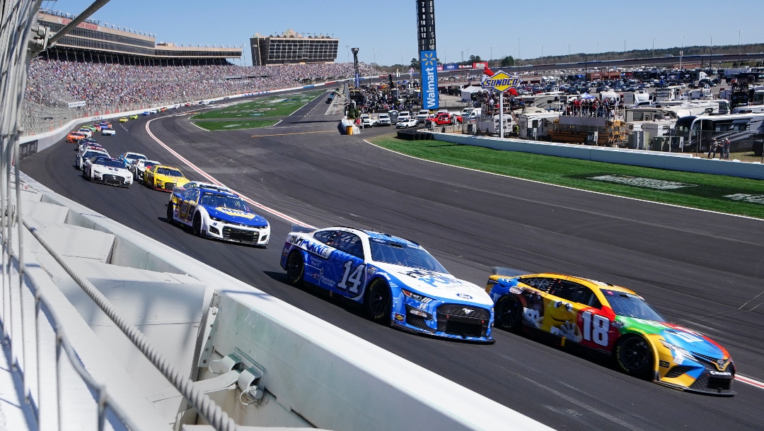 NASCAR Cup Series drivers Chase Briscoe (14) and Kyle Busch (18) race into the first turn in the NASCAR Cup Series auto race at Atlanta Motor Speedway in Hampton, Ga., Sunday, March 20, 2022,