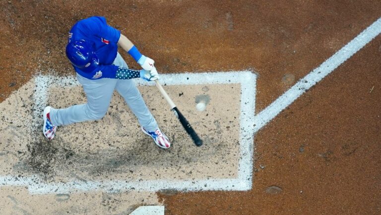 Chicago Cubs' Ian Happ hits a double during the fourth inning of a baseball game against the Milwaukee Brewers Monday, July 4, 2022, in Milwaukee.