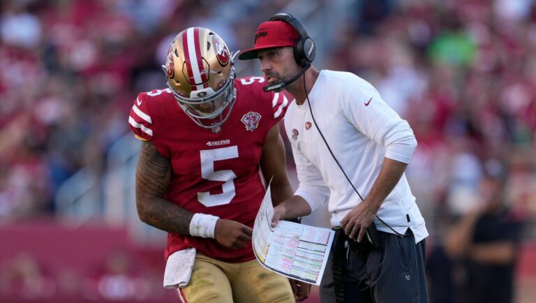 San Francisco 49ers head coach Kyle Shanahan, right, talks with quarterback Trey Lance (5) during the second half of an NFL football game against the Seattle Seahawks in Santa Clara, Calif., Sunday, Oct. 3, 2021. (AP Photo/Tony Avelar)