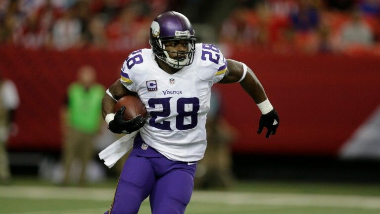 Minnesota Vikings running back Adrian Peterson (28) runs against the Atlanta Falcons during the first half of an NFL football game, Sunday, Nov. 29, 2015, in Atlanta.