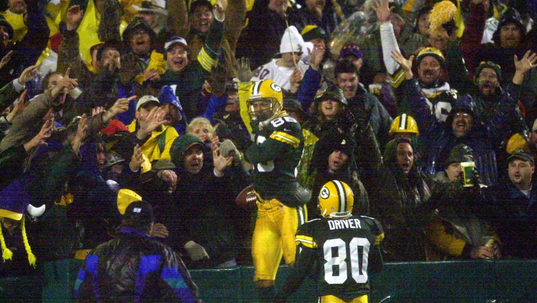 Green Bay Packers' Antonio Freeman celebrates with fans after making the game-winning touchdown in overtime to beat the Minnesota Vikings 26-20 Monday, Nov. 6, 2000, in Green Bay, Wis.