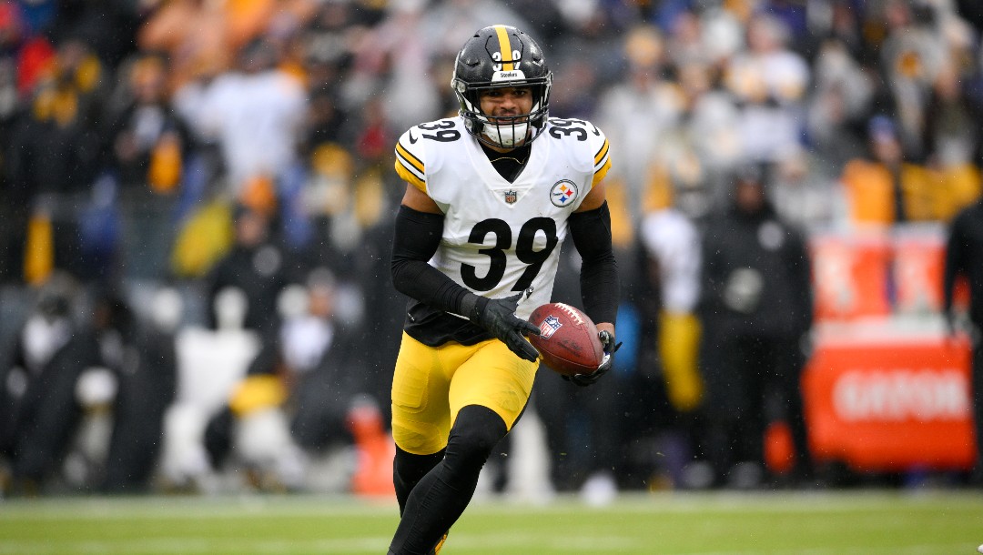 Pittsburgh Steelers free safety Minkah Fitzpatrick runs with the ball after intercepting a pass from Baltimore Ravens quarterback Tyler Huntley during the first half of an NFL football game, Sunday, Jan. 9, 2022, in Baltimore. (AP Photo/Nick Wass)