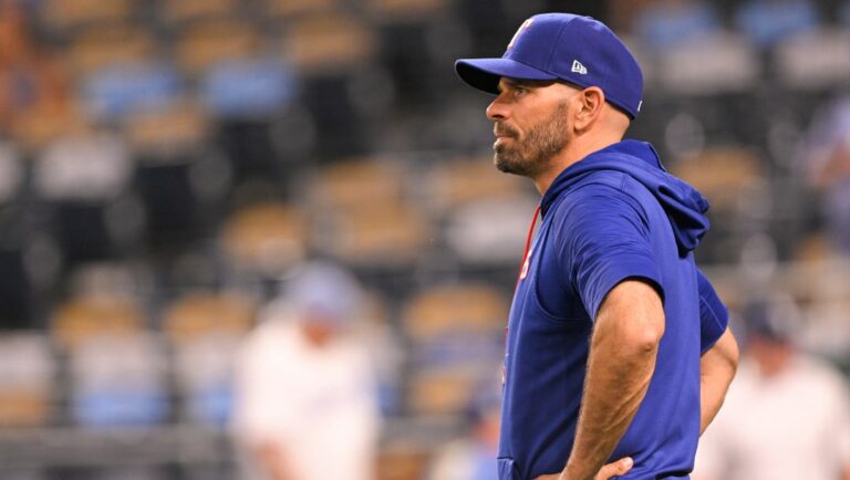 Texas Rangers manager Chris Woodward waits for players to come off the field after a win over the Kansas City Royals in a baseball game Tuesday, June 28, 2022, in Kansas City, Mo.