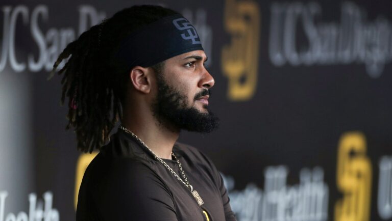FILE - San Diego Padres' Fernando Tatis Jr. looks out from the dugout prior to the team's baseball game against the Philadelphia Phillies on June 25, 2022, in San Diego. Tatis was suspended 80 games by Major League Baseball on Friday, Aug. 12, after testing positive for a performance-enhancing substance. The penalty was effective immediately, meaning the All-Star shortstop cannot play in the majors this year. Tatis had been on the injured list all season after breaking his left wrist in spring training.