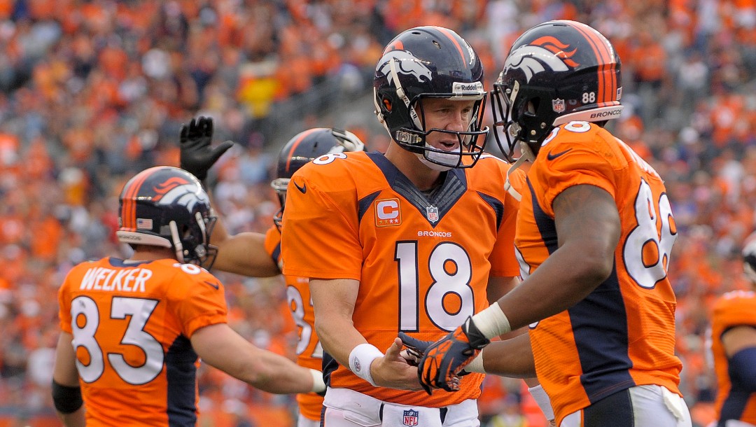 ADVANCE FOR WEEKEND EDITIONS, JAN. 25-26 - In this Sept. 29, 2013, file photo, Denver Broncos quarterback Peyton Manning (18) is congratulated by wide receiver Demaryius Thomas (88) after throwing a touchdown pass to Wes Welker during the third quarter of an NFL football game against the Philadelphia Eagles in Denver. No team in the 93-year history of the NFL ever had that many players catch at least 60 passes or reach the end zone 10 or more times until the Broncos put up a record 606 points. (AP Photo/Jack Dempsey, File)
