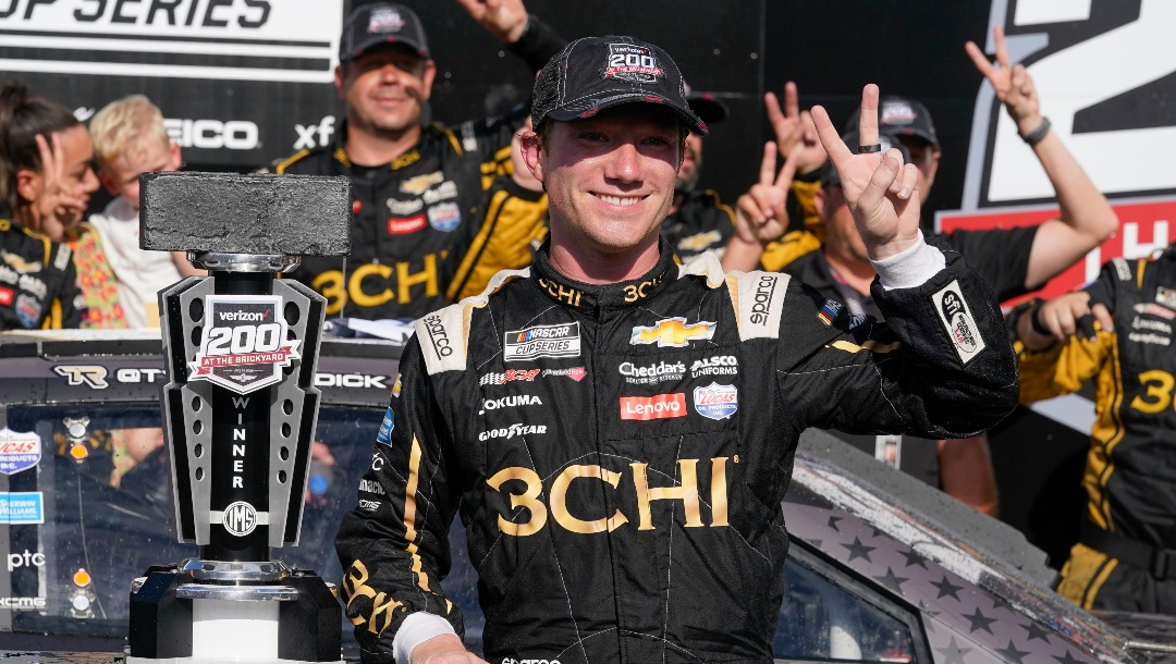 Tyler Reddick celebrates after winning a NASCAR Cup Series auto race at Indianapolis Motor Speedway, Sunday, July 31, 2022, in Indianapolis. (AP Photo/Darron Cummings)