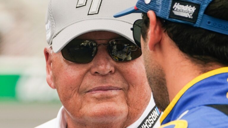 Team owner Rick Hendrick, left, talks with driver Chase Elliott at a NASCAR Cup Series auto race at Atlanta Motor Speedway, Sunday, July 10, 2022, in Hampton, Ga. (AP Photo/John Bazemore)