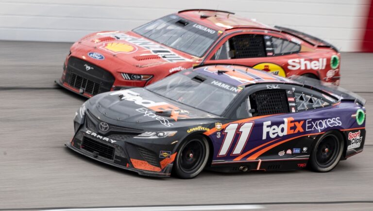 Denny Hamlin (11) passes Joey Logano (22) during a NASCAR Cup Series auto race at Darlington Raceway, Monday, May 9, 2022, in Darlington, S.C. (AP Photo/Matt Kelley)