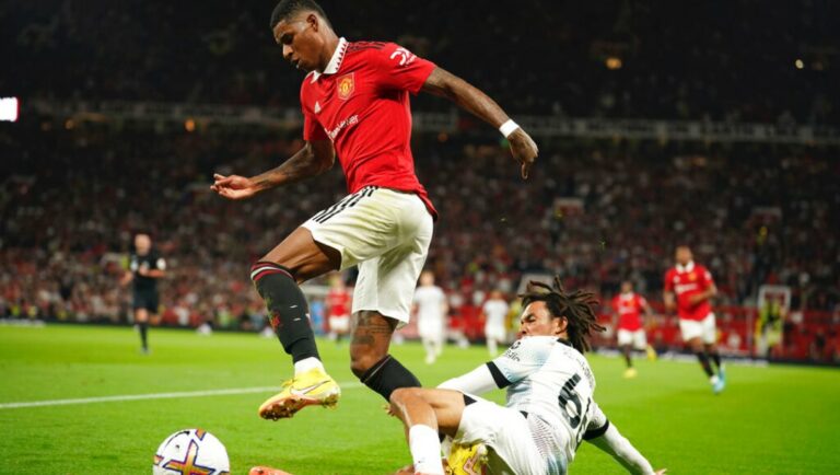 Manchester United's Marcus Rashford, left, challenges for the ball with Liverpool's Trent Alexander-Arnold.