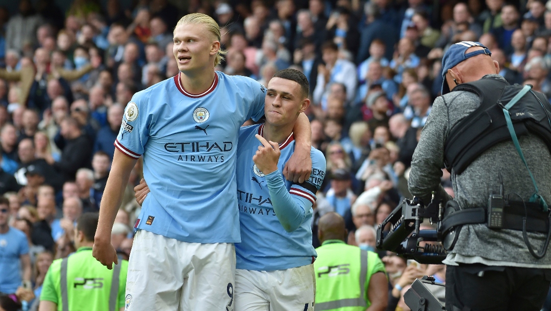Manchester City's Phil Foden, right, celebrates with his teammate Erling Haaland after scoring his side's sixth goal and his personal hat trick during the English Premier League soccer match between Manchester City and Manchester United at Etihad stadium in Manchester, England, Sunday, Oct. 2, 2022.