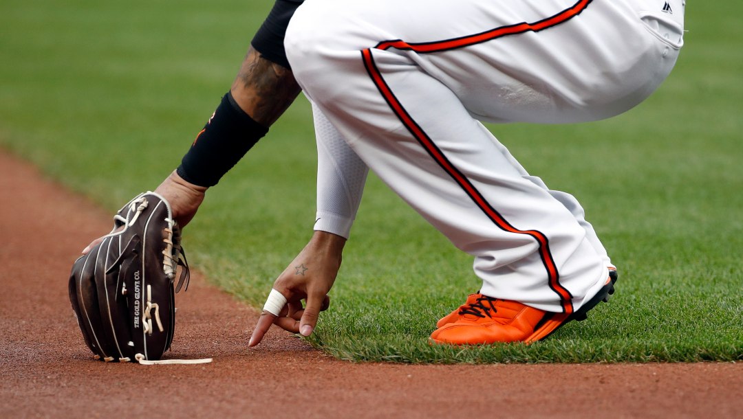 Baltimore Orioles third baseman Manny Machado writes in the infield dirt before a baseball game against the Houston Astros in Baltimore, Friday, July 21, 2017.