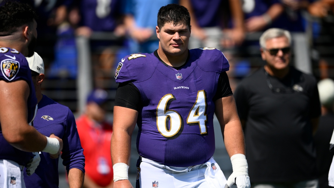 Baltimore Ravens center Tyler Linderbaum (64) warms up