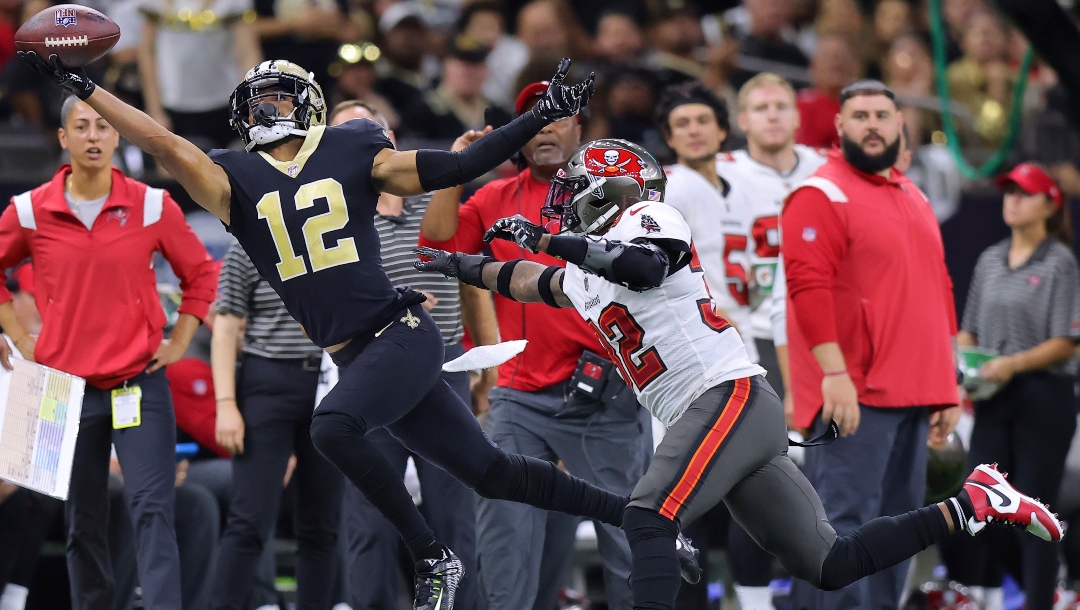 New Orleans Saints wide receiver Chris Olave (12) attempts to catch the ball