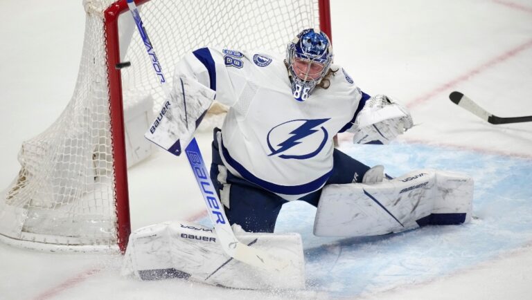 Tampa Bay Lightning goaltender Andrei Vasilevskiy uses his shoulder to deflect a shot by the Colorado Avalanche during the first period of an NHL hockey game Thursday, Feb. 10 2022, in Denver.