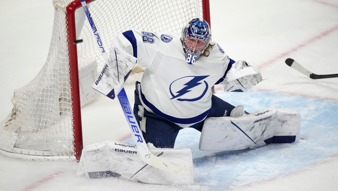 Tampa Bay Lightning goaltender Andrei Vasilevskiy uses his shoulder to deflect a shot by the Colorado Avalanche during the first period of an NHL hockey game Thursday, Feb. 10 2022, in Denver.
