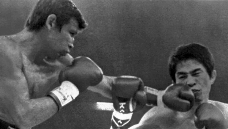 Mexican Miguel Canto, left, lands a left to the chin of champion Shoji Oguma of Japan, in the first round.