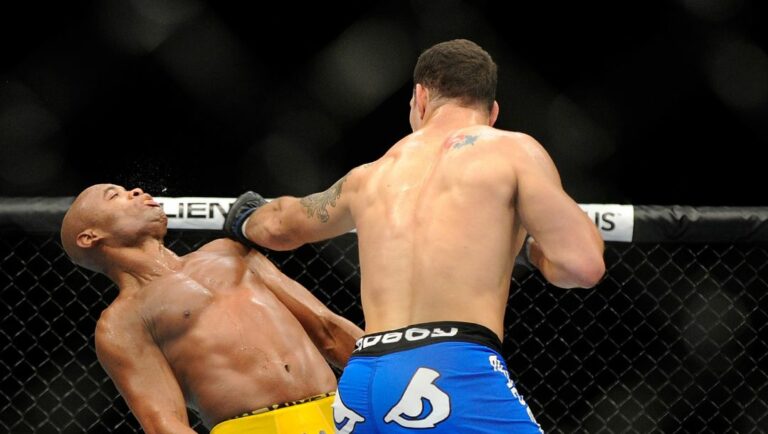 Chris Weidman connects with Anderson Silva during the second round during their UFC 162 mixed martial arts.