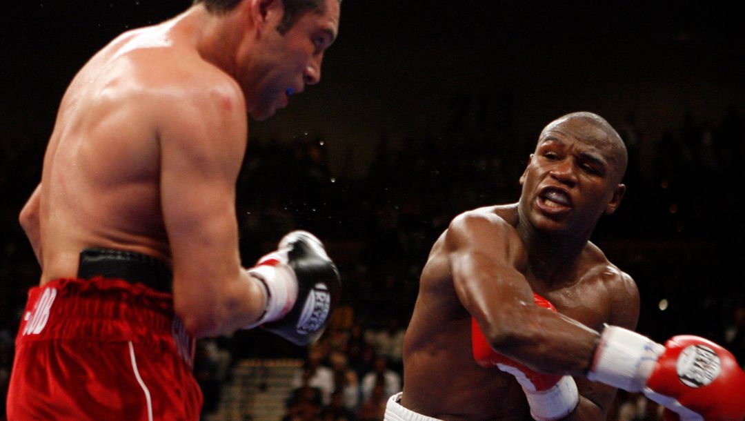 Floyd Mayweather, right, throws a looping right hand against Oscar De La Hoya during their WBC super welterweight world championship.