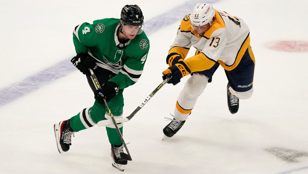 Dallas Stars defenseman Miro Heiskanen (4) and Nashville Predators center Yakov Trenin (13) skate after the puck during the second period of an NHL hockey game in Dallas, Saturday, Oct. 15, 2022.
