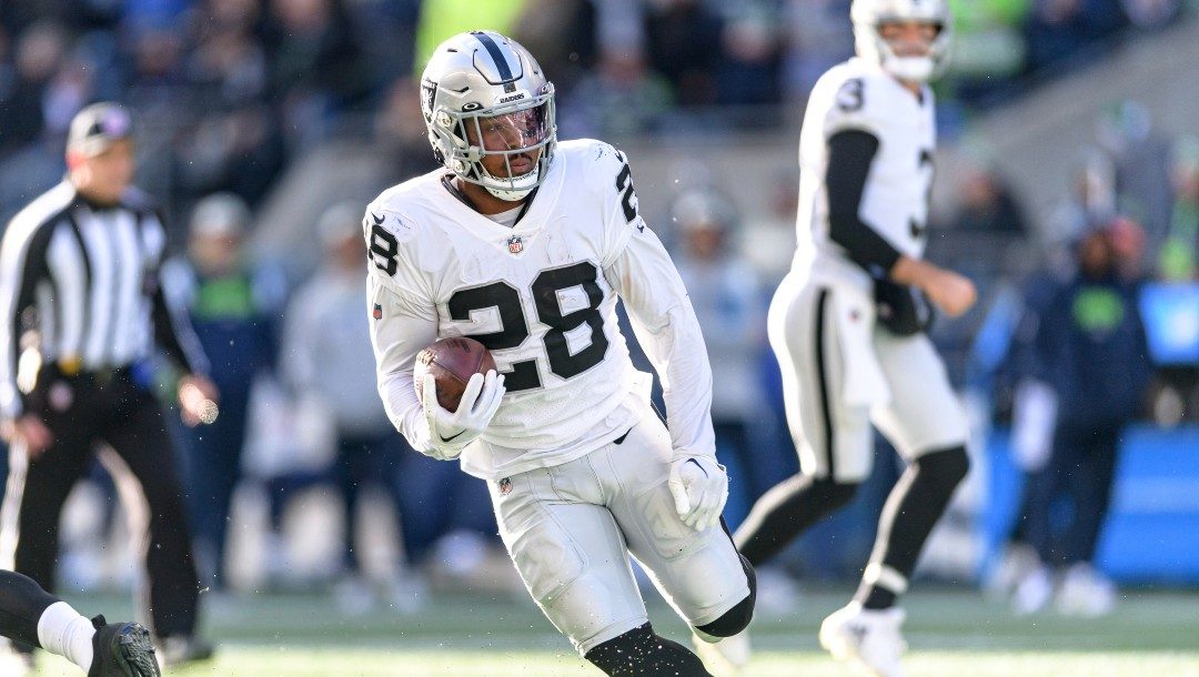 Las Vegas Raiders running back Josh Jacobs rushes with the football during an NFL football game against the Seattle Seahawks, Sunday, Nov. 27, 2022, in Seattle.The Raiders won 40-34 in overtime.