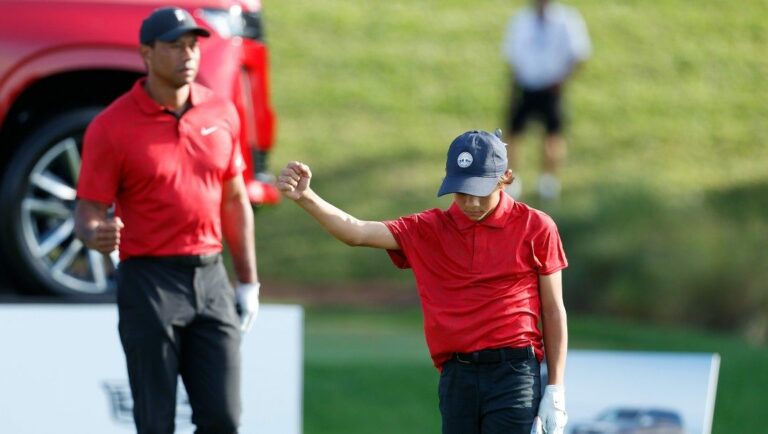 Charlie Woods reacts to his tee shot on the17th hole under watch from father Tiger Woods during the second round of the PNC Championship golf tournament Sunday, Dec. 19, 2021, in Orlando, Fla.
