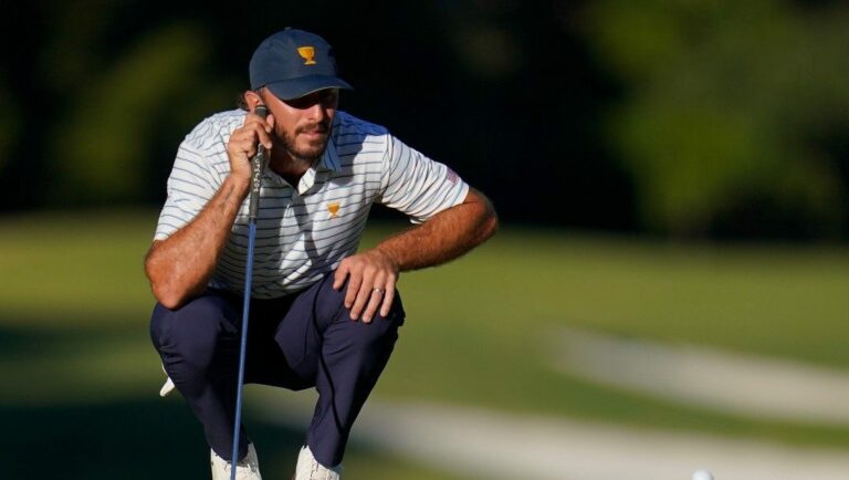 Max Homa lines up his putt on the 17th hole during their fourball match at the Presidents Cup golf tournament at the Quail Hollow Club, Friday, Sept. 23, 2022, in Charlotte, N.C.