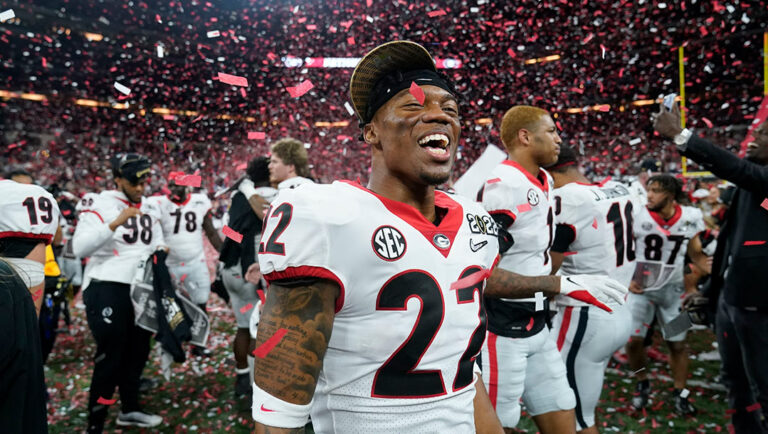 Georgia Bulldogs football player number 22, standing after winning a game