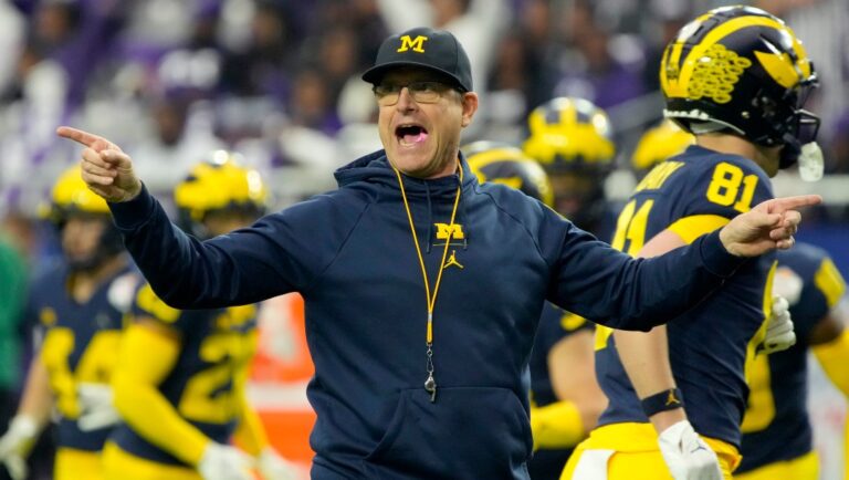 Michigan head coach Jim Harbaugh watches his players prior to the Fiesta Bowl NCAA college football semifinal playoff game against TCU, Saturday, Dec. 31, 2022, in Glendale, Ariz. (AP Photo/Rick Scuteri)