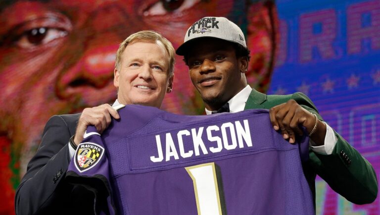 Commissioner Roger Goodell, left, presents Louisville's Lamar Jackson with his Baltimore Ravens jersey during the first round of the NFL football draft, Thursday, April 26, 2018, in Arlington, Texas. (AP Photo/David J. Phillip)
