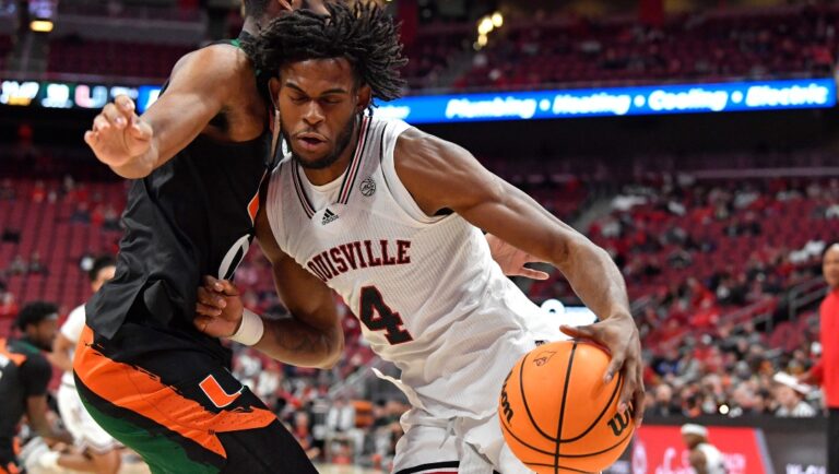 Louisville forward Roosevelt Wheeler (4) tries to get past Miami forward A.J. Casey during the second half of an NCAA college basketball game in Louisville, Ky., Sunday, Dec. 4, 2022. Miami won 80-53. (AP Photo/Timothy D. Easley)