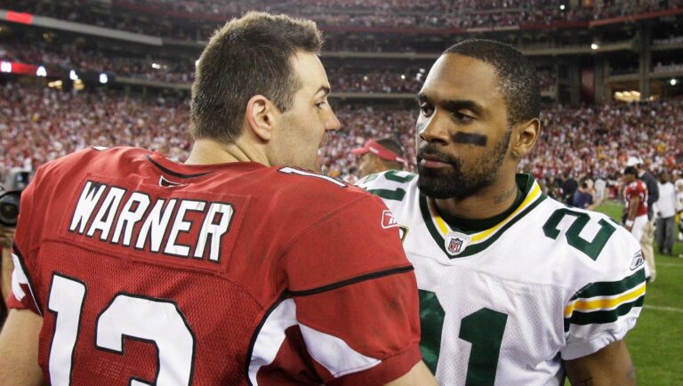 Arizona Cardinals' Kurt Warner (13) talks to Green Bay Packers' Charles Woodson (21) after overtime of an NFL wild-card playoff football game Sunday, Jan. 10, 2010, in Glendale, Ariz. Arizona won 51-45. (AP Photo/Ross D. Franklin)
