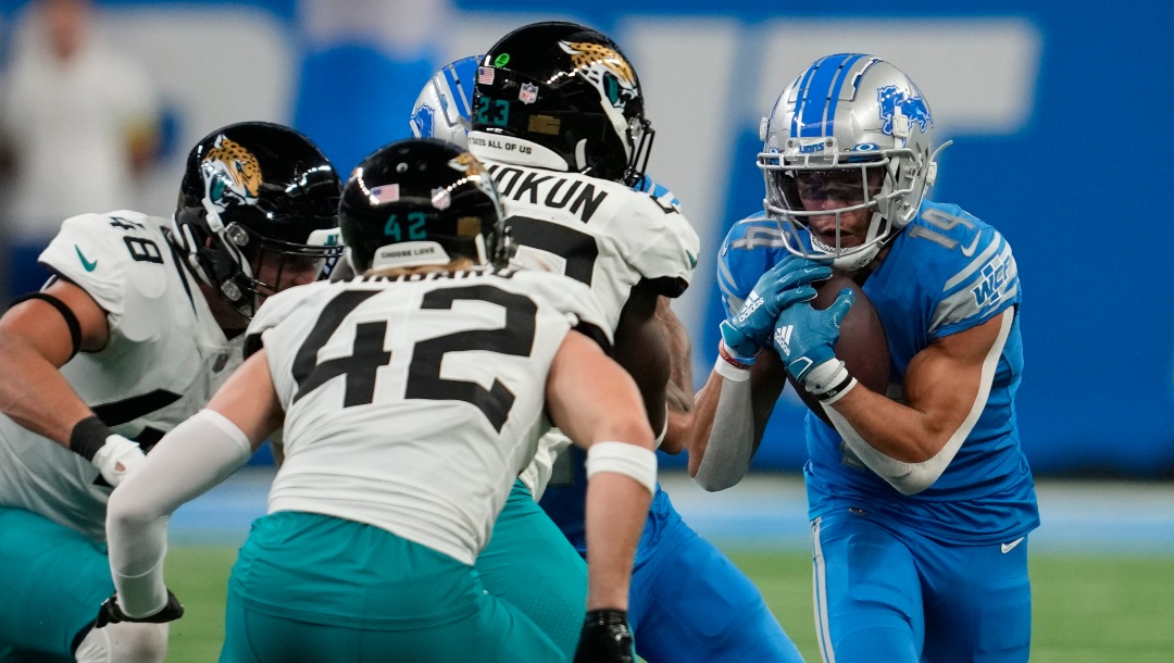 Detroit Lions wide receiver Amon-Ra St. Brown (14) runs after a catch against the Jacksonville Jaguars during an NFL football game in Detroit, Sunday, Dec. 4, 2022. (AP Photo/Paul Sancya)