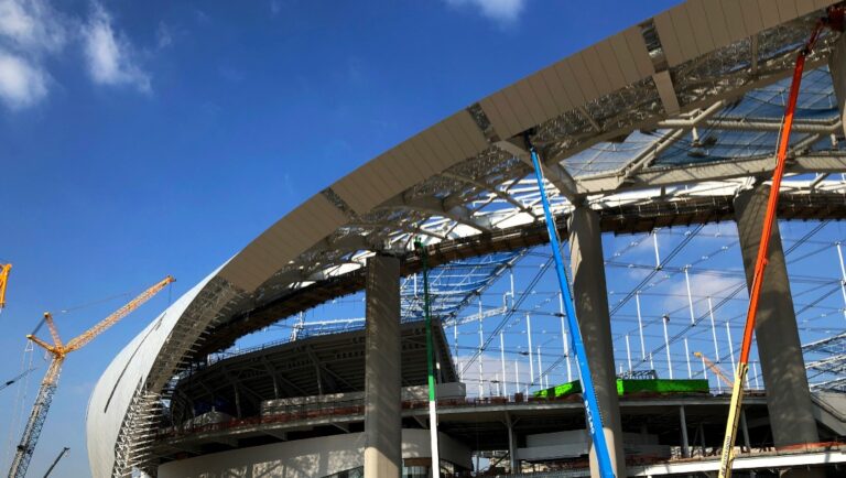 Workers and cranes continue construction on the south entrance to SoFi Stadium in Inglewood, Calif., on Wednesday, Jan. 22, 2020. The estimated $5 billion project is on schedule to open in July as the most expensive stadium in NFL history. (AP Photo/Greg Beacham)