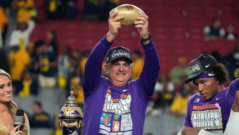 TCU head coach Sonny Dykes holds the trophy after the Fiesta Bowl NCAA college football semifinal playoff game, Saturday, Dec. 31, 2022, in Glendale, Ariz. TCU defeated Michigan 51-45. (AP Photo/Rick Scuteri)