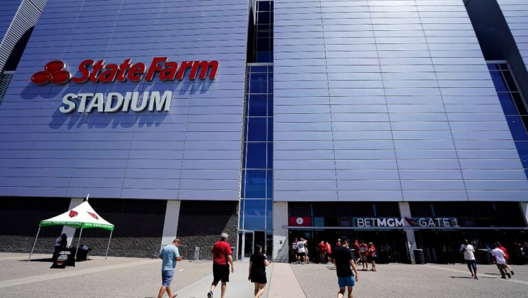 Football fans enter State Farm Stadium before an NFL football game between the Arizona Cardinals and Kansas City Chiefs, Sunday, Sept. 11, 2022, in Glendale, Ariz. (AP Photo/Darryl Webb)